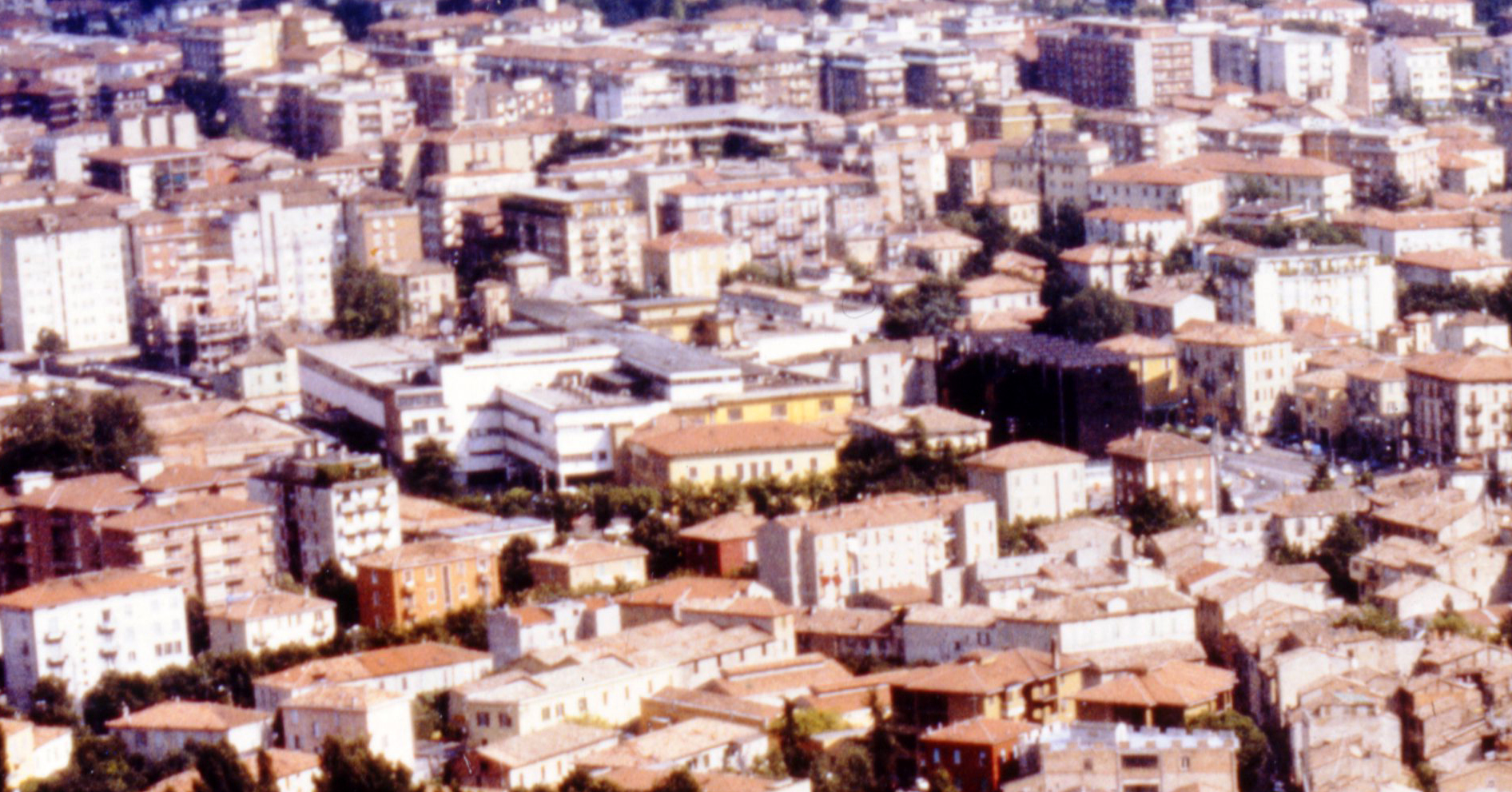 Aerial view facing South-West of the suburbian neighborhoods of the city of Parma with the Barilla plant in the center.